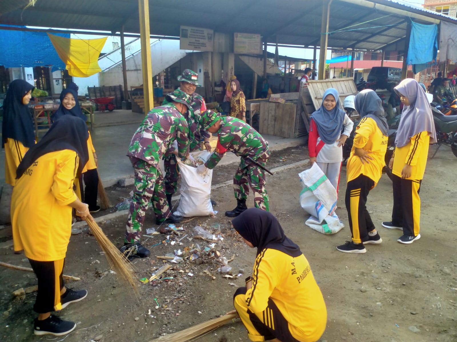Anggota Koramil 1402-04/Tinambung Gandeng Pelajar dan Warga Bersihkan Lingkungan Pasar