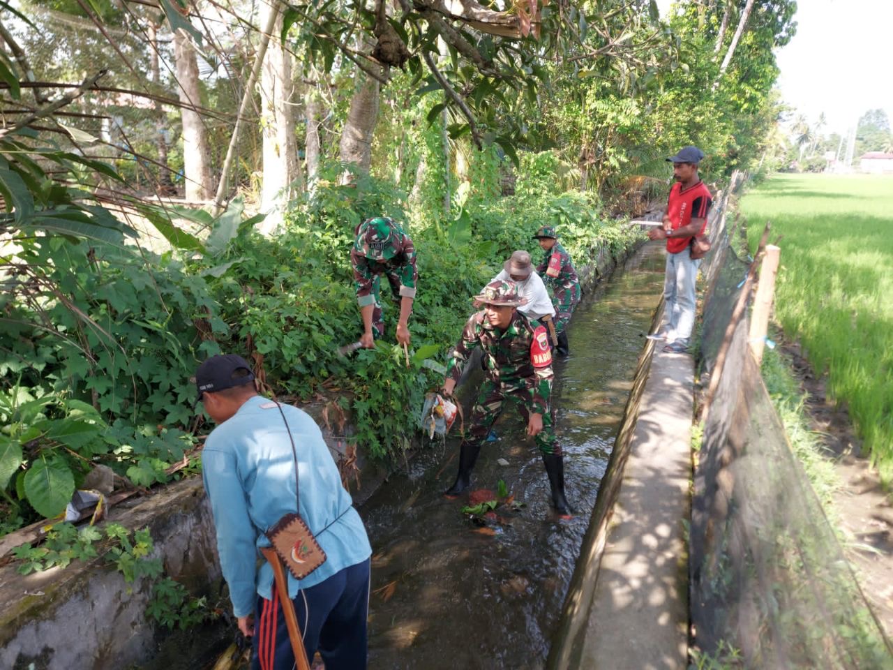 Penuhi Kebutuhan Air Petani, Babinsa Koramil 07 Kodim 1404/Pinrang Bersama Warga Bersihkan Saluran Irigasi